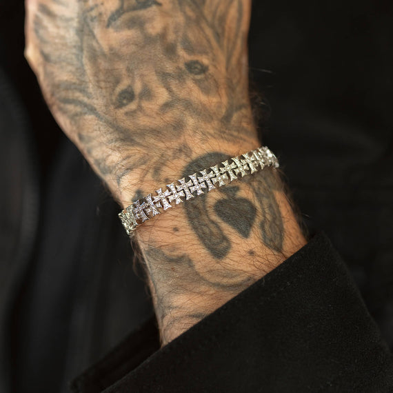 Wrist close up with silver iced bracelet and black background