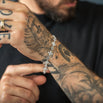 tattooed arm with iced bracelet and blurry background