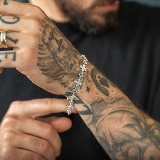 tattooed arm with iced bracelet and blurry background