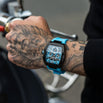 The Intrepid Sport - Arctic Blue men's luxury watch featuring a bold blue strap, black rectangular case, and intricate dial with chronograph subdials, worn on a tattooed wrist, statement luxury watch by Ralph Christian. Bold by Design.