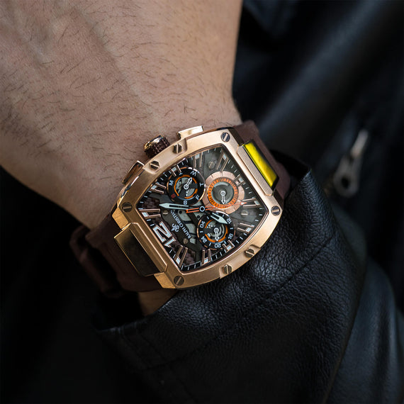 The Intrepid Sport - Gilded Brown men's luxury watch with a bold gilded case, brown leather strap, detailed 24-hour subdial, day and date functions, and chronograph subdials, bold by design.
