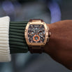 The Intrepid Sport - Gilded Brown men's luxury watch with a bold gilded case, brown strap, and detailed dial featuring 24-hour subdial, day and date functions, and chronograph markers.