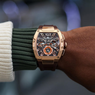 The Intrepid Sport - Gilded Brown men's luxury watch with a bold gilded case, brown strap, and detailed dial featuring 24-hour subdial, day and date functions, and chronograph markers.
