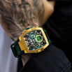 The Intrepid Sport - Gold men's luxury watch features a bold gold-tone case, green accents on the dial with 24-hour subdial, day and date functions, and a green strap, statement luxury watch designed to be noticed. Bold by Design.