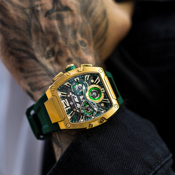 The Intrepid Sport - Gold men's luxury watch features a bold gold-tone case, green accents on the dial with 24-hour subdial, day and date functions, and a green strap, statement luxury watch designed to be noticed. Bold by Design.