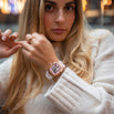 The Intrepid Sport Ladies - Sakura Blush women's luxury watch with rose gold case pink jeweled dial and white strap worn by a woman in a lifestyle shot