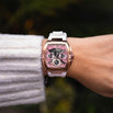 The Intrepid Sport Ladies - Sakura Blush women's luxury watch with rose gold case, pink chronograph dial, and white strap shown on the wrist