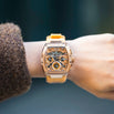 The Intrepid Sport Ladies - Sunkiss Bronze wristwatch with a bronze-toned angular case, detailed multi-function dial, and a matching yellow strap on a female wrist, bold by design.