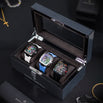 Luxury Collectors Watch Case displaying three automatic chronograph watches with colorful dials and leather straps, set on a sleek textured surface in a stylish lifestyle setting.