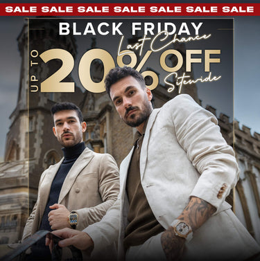 Two men sitting at a table outdoors with a magazine on the table.