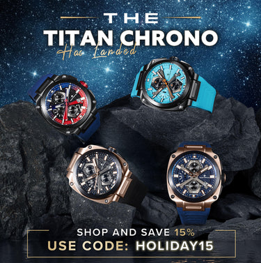 Two men sitting at a table outdoors with a magazine on the table.