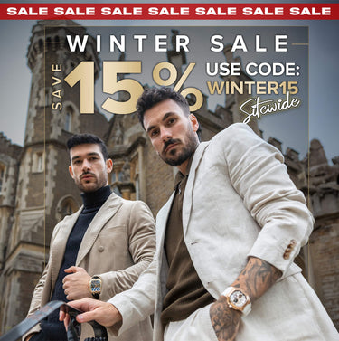 Two men sitting at a table outdoors with a magazine on the table.