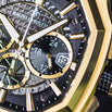 Close-up of a Ralph Christian watch with gold and black design