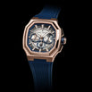 Luxury watch with blue strap and rose gold case on black background
