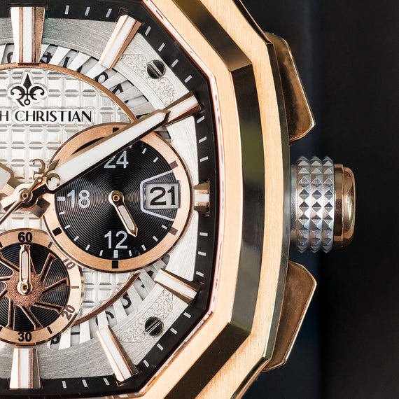 Luxury watch with rose gold case and detailed face on a dark background