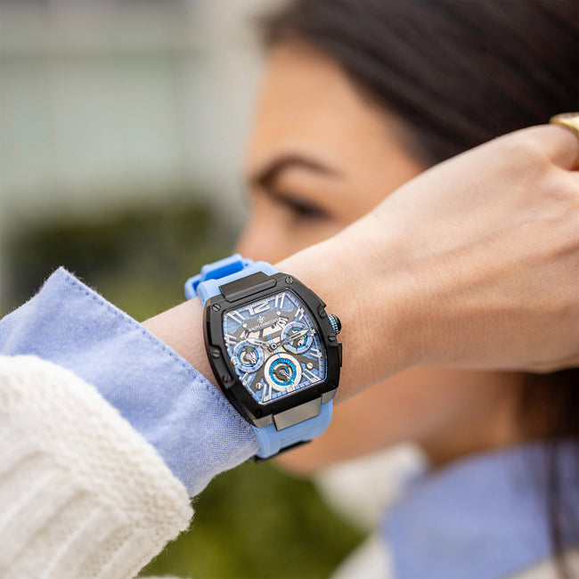 A close-up lifestyle shot of The Intrepid Sport Ladies - Blue Mirage, featuring a bold black case, intricate chronograph subdials, and a vibrant blue strap, worn on wrist.