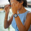 Woman wearing The Intrepid Sport Ladies - Blue Mirage watch with a bold blue and white strap and detailed dial, styled with casual blue sleeveless top and delicate jewelry, bold by design.