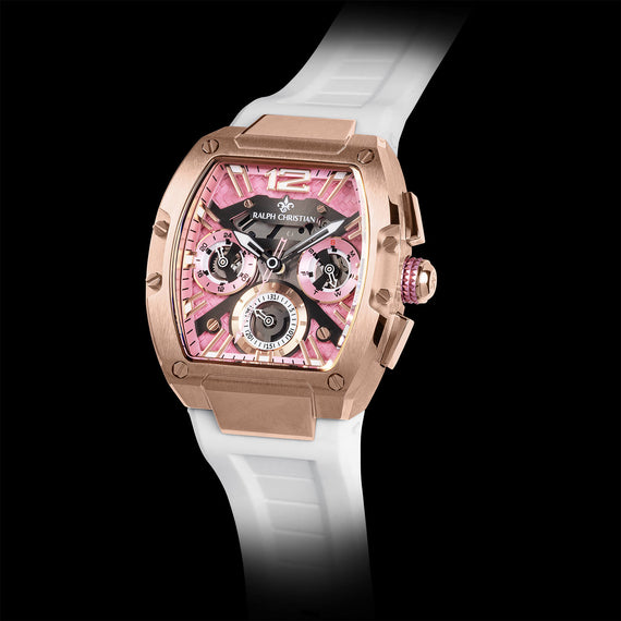 The Intrepid Sport Ladies - Sakura Blush rose gold watch with pink chronograph subdials, textured dial, crystal accents, and white rubber strap on black background
