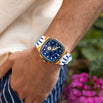 The Legacy Chrono Ice - Sapphire Royale men's luxury watch with a blue dial, gold-tone case, white and blue strap, chronograph subdials, and sapphire-coated crystal on wrist, bold by design.