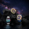Three bold men's luxury watches from The Polaris Chrono Ice - Arctic Prism collection displayed on dark volcanic rocks against a starry night sky, featuring colorful iced bezels, chronograph subdials, and contrasting straps in black, white, and blue, embodying statement luxury with intricate detailing and sapphire-coated crystal, bold by design.
