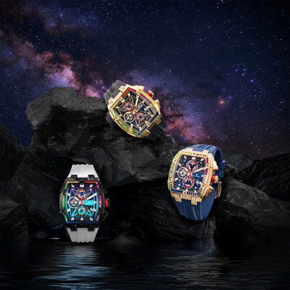 Three bold men's luxury watches from The Polaris Chrono Ice - Arctic Prism collection displayed on dark volcanic rocks against a starry night sky, featuring colorful iced bezels, chronograph subdials, and contrasting straps in black, white, and blue, embodying statement luxury with intricate detailing and sapphire-coated crystal, bold by design.