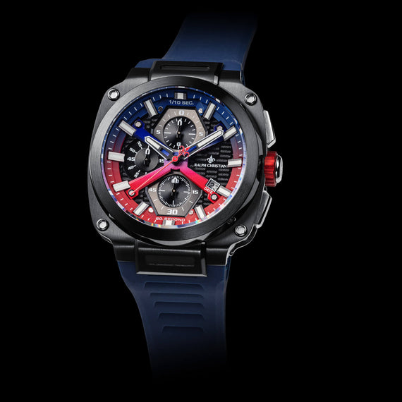 Luxury watch with a blue strap and multicolored face on a black background