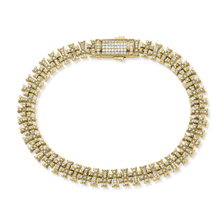 Gold bracelet with diamond accents on a white background