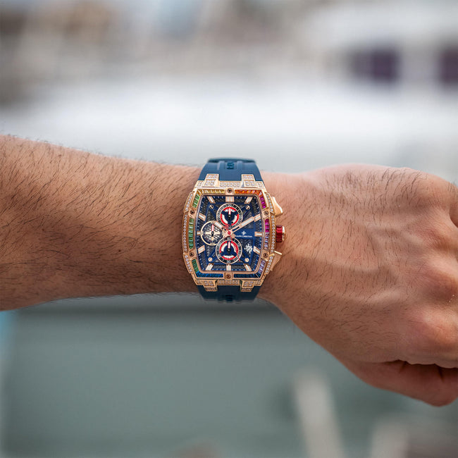 The Polaris Chrono Ice - Celestial Nova on a wrist, featuring a bold rectangular icy-set bezel with rose gold case, blue dial with chronograph subdials, red accents, and a blue strap.
